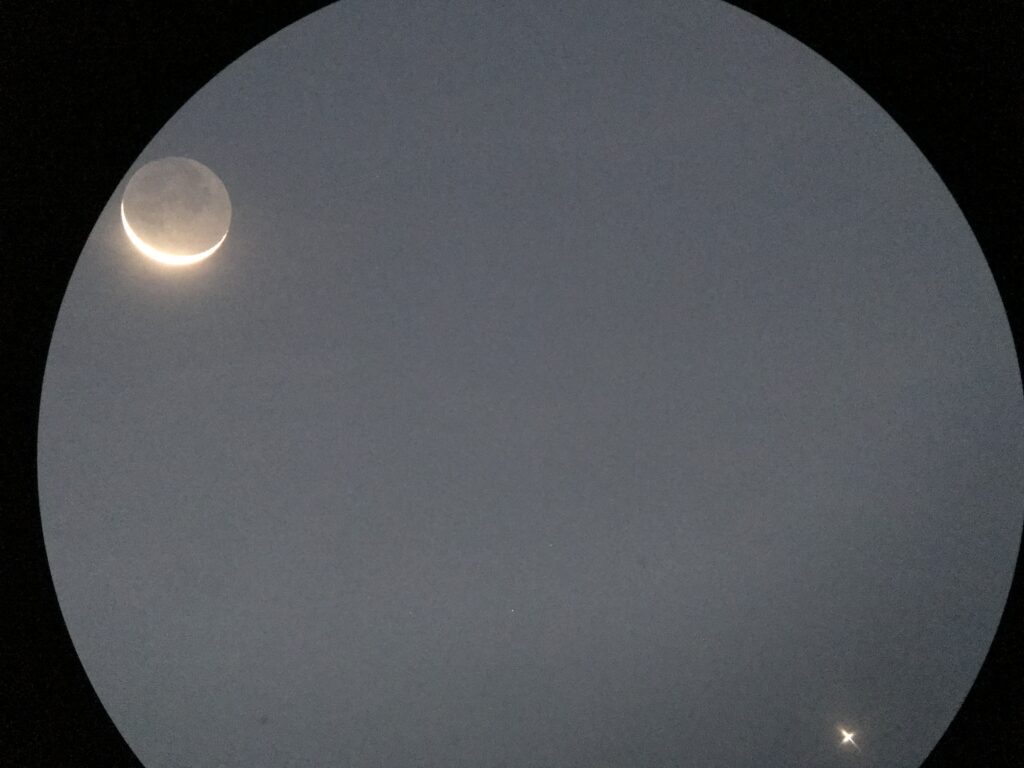 Partial solar eclipse: the Moon covers part of the Sun, creating a bright crescent edge in a dark sky as seen in a circular framing.